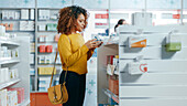 Female customer looking at box of medication