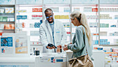 Female customer holding box of medication