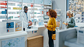 Female customers in line at pharmacy checkout