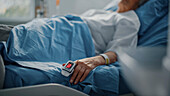 Elderly patient wearing pulse oximeter