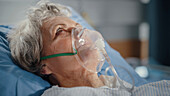 Elderly patient wearing oxygen mask