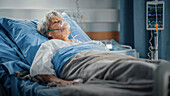 Elderly patient sleeping wearing oxygen mask