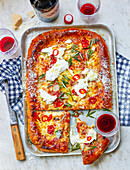 Pizza tray with three types of cheese and pickled chilli peppers