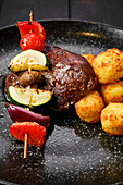 Grilled beef with vegetable skewer and potato balls