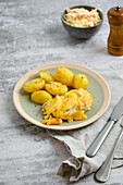 Pork chops baked with cheese with roast potatoes and coleslaw