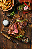 Grilled beef steak with herbs and potato wedges