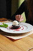 Brownie with vanilla ice cream and raspberry sauce