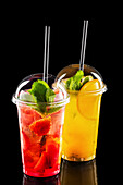 Refreshing strawberry and orange lemonade in a take-away cup