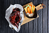 Chicken wings with carrot and celery sticks and dip