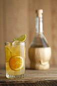 Vodka-orange cocktail with orange and lime slices