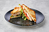 Club sandwich with chicken, tomato, cheese and salad