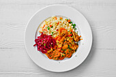 Beef goulash with rice, peas and beetroot salad