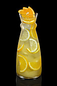 Lemon and orange lemonade in a glass carafe