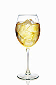 Apple and sparkling wine cocktail with ice cubes