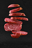 Floating slices of smoked beef salami