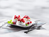 Meringue tartlet with whipped cream and fresh raspberries