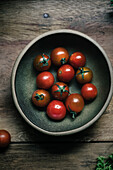 Still life of a bowl of fresh cherry tomatoes