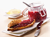 Wholemeal bread roll with damson jam and butter