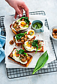 Toasted baguette with wild garlic spread, egg and mushrooms