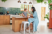 Mother with daughter in kitchen