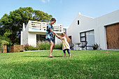 Brother and sister playing in backyard