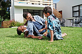 Father with children playing in backyard