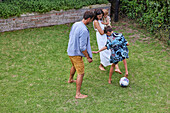 Parents with children playing in backyard