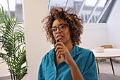 Portrait of woman talking to microphone in creative studio