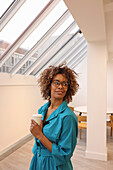 Smiling woman standing in creative studio