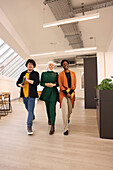 Smiling workers walking in modern office