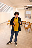 Man with cup in office