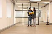 Coworkers talking in empty office