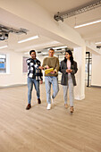 Coworkers talking in empty office