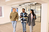 Coworkers talking in empty office