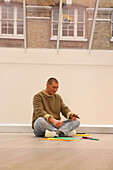 Man sitting on floor in modern office