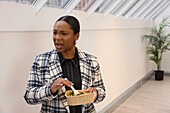 Businesswoman enjoying salad in office