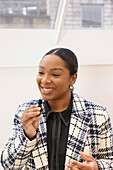 Woman talking to microphone in office