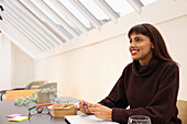 Businesswoman sitting at table in office