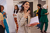 Employee holding notebook during team meeting