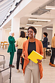 Employee holding folder and smiling during meeting