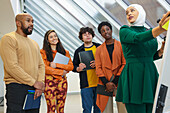 Employees having team meeting in office