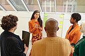 Employees having team meeting in office