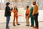 Employees having team meeting in office