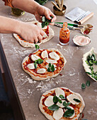 Margherita pizza is placed in the wood-fired oven