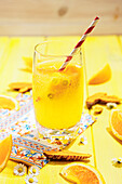 Orange juice in a glass with paper straw