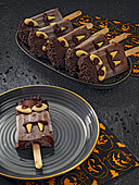 Homemade chocolate ice cream on a stick with Halloween decoration