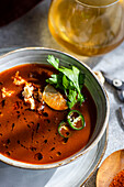 Spicy cream of tomato soup with cream cheese and parsley