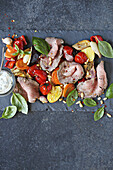 Roast beef with oven vegetables and yoghurt dip