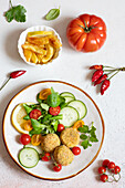 Cannellini bean balls with salad and chips