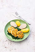 Salmon meatballs with spinach, Jerusalem artichokes and jacket potatoes